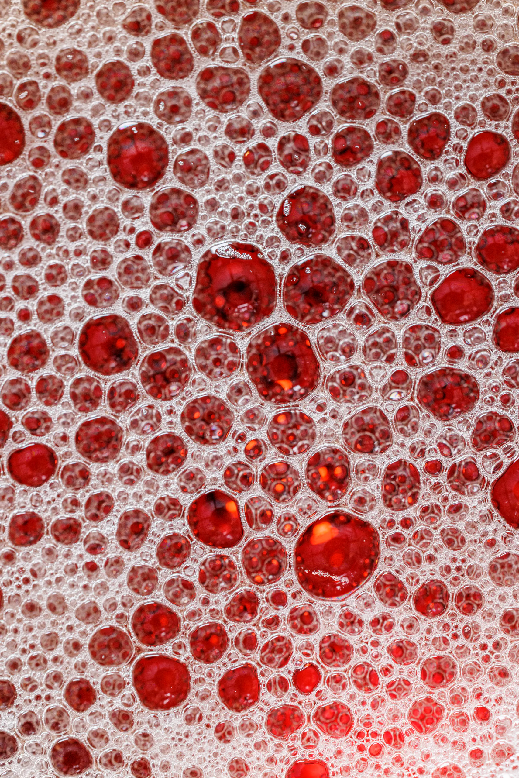 Abstract macro close-up of red foam and bubbles on a drink — Camparino in Galleria, Milan