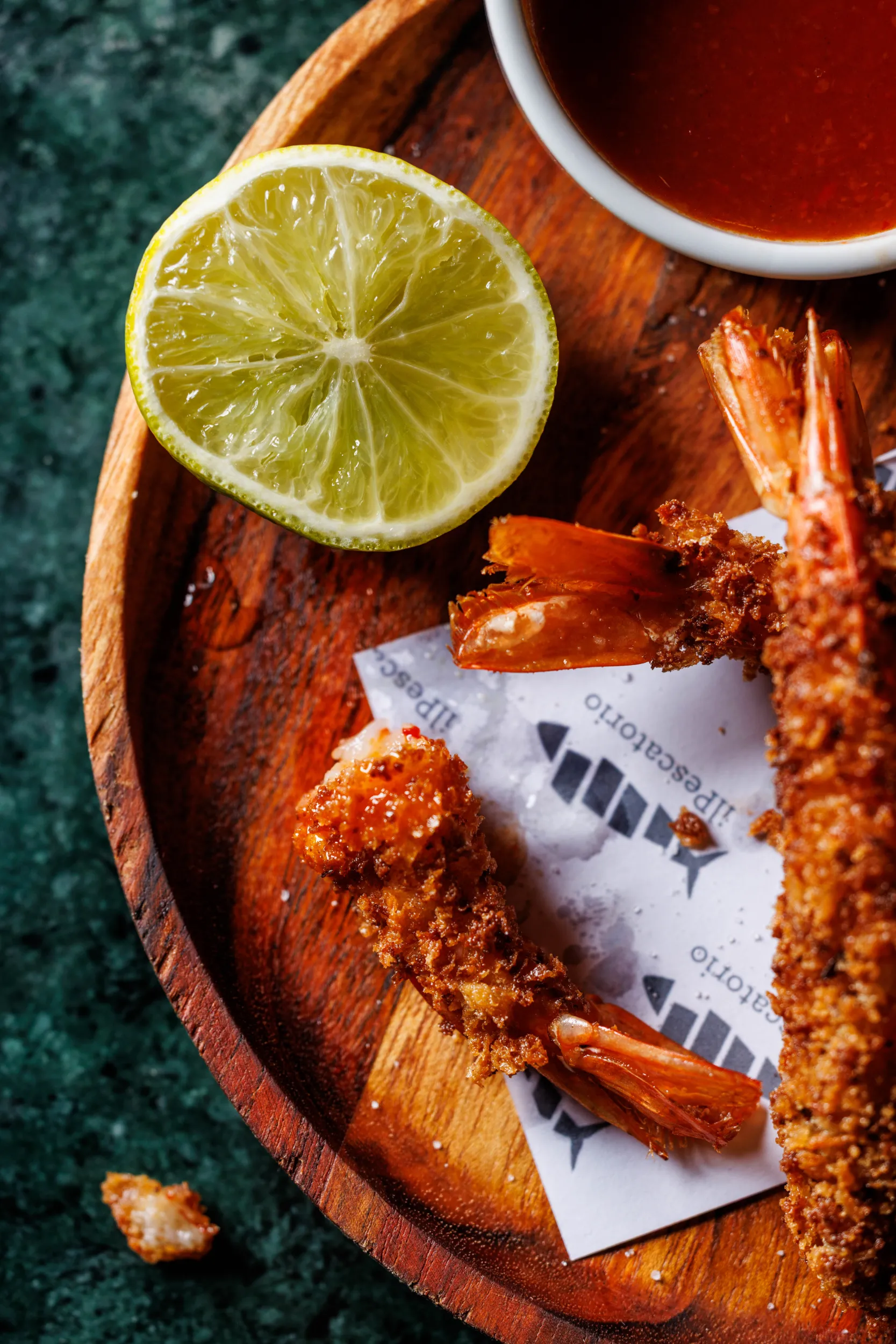 Fried prawns with lime and dipping sauce on a wooden board - Il Pescatorio, Rome, Italy