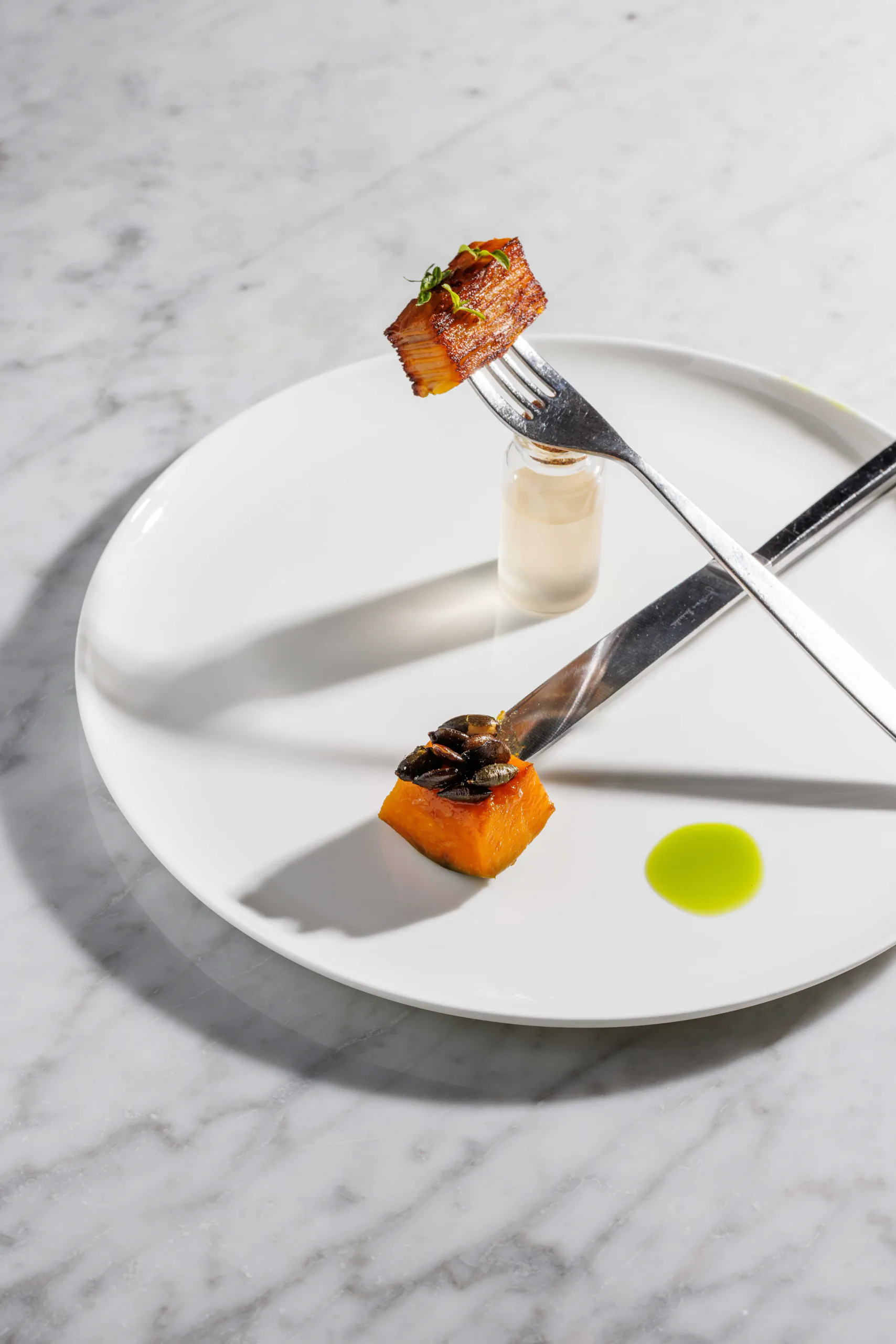 Minimalist plated dish with glazed morsels and green oil - Bistrot64, Rome, Italy