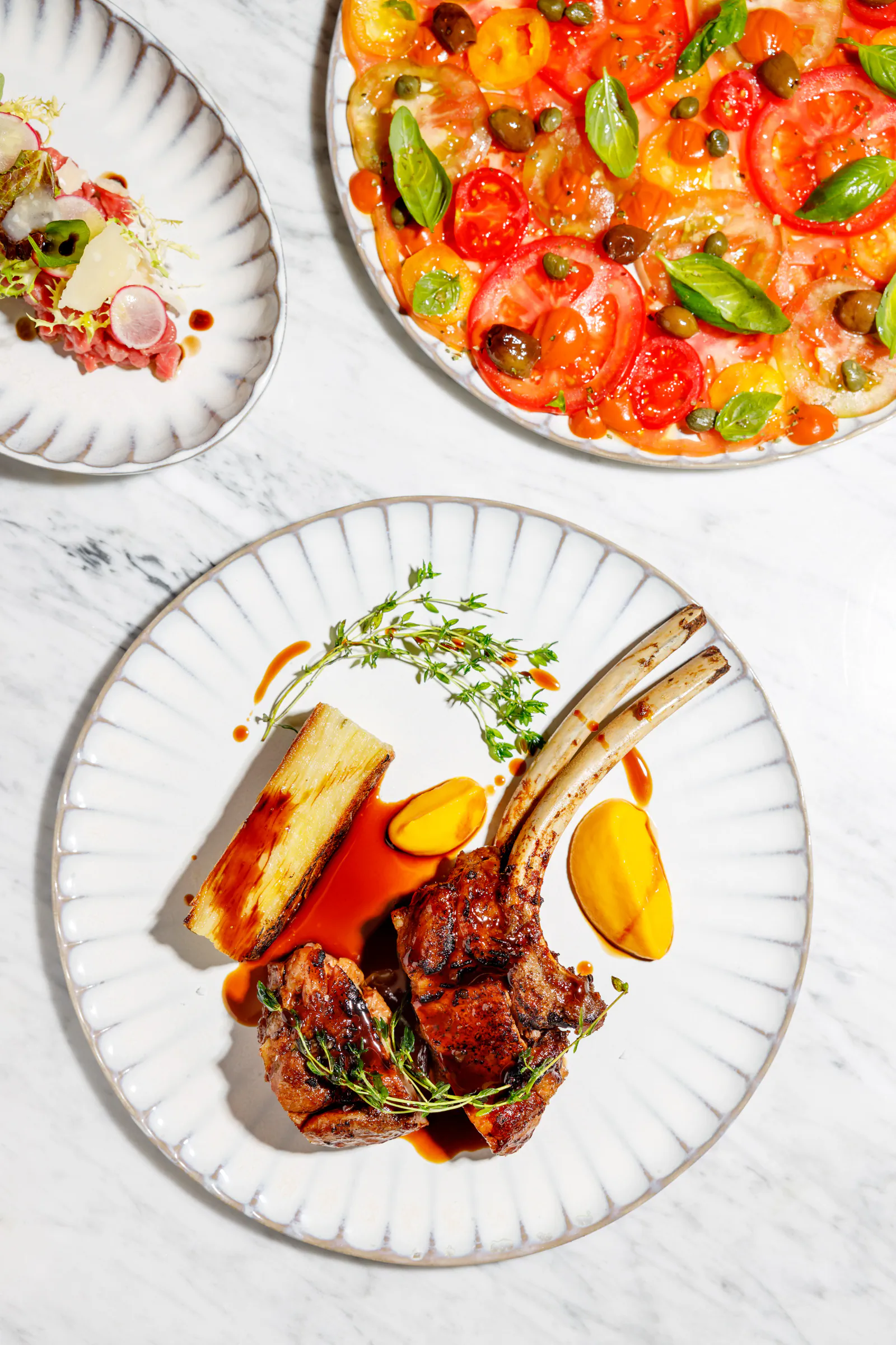 Rack of lamb and tomato dishes plated, seen from above - Giano at W Rome, Rome, Italy
