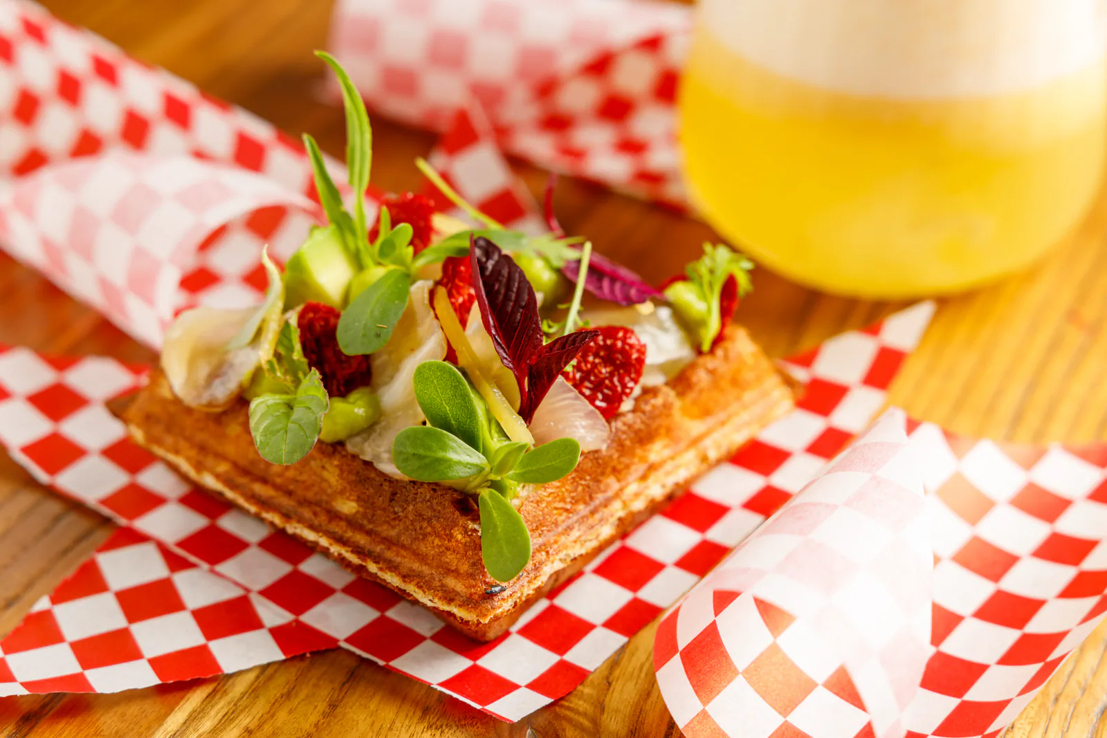 Ceviche waffle topped with avocado and greens, with a beer - Carnal, Rome, Italy