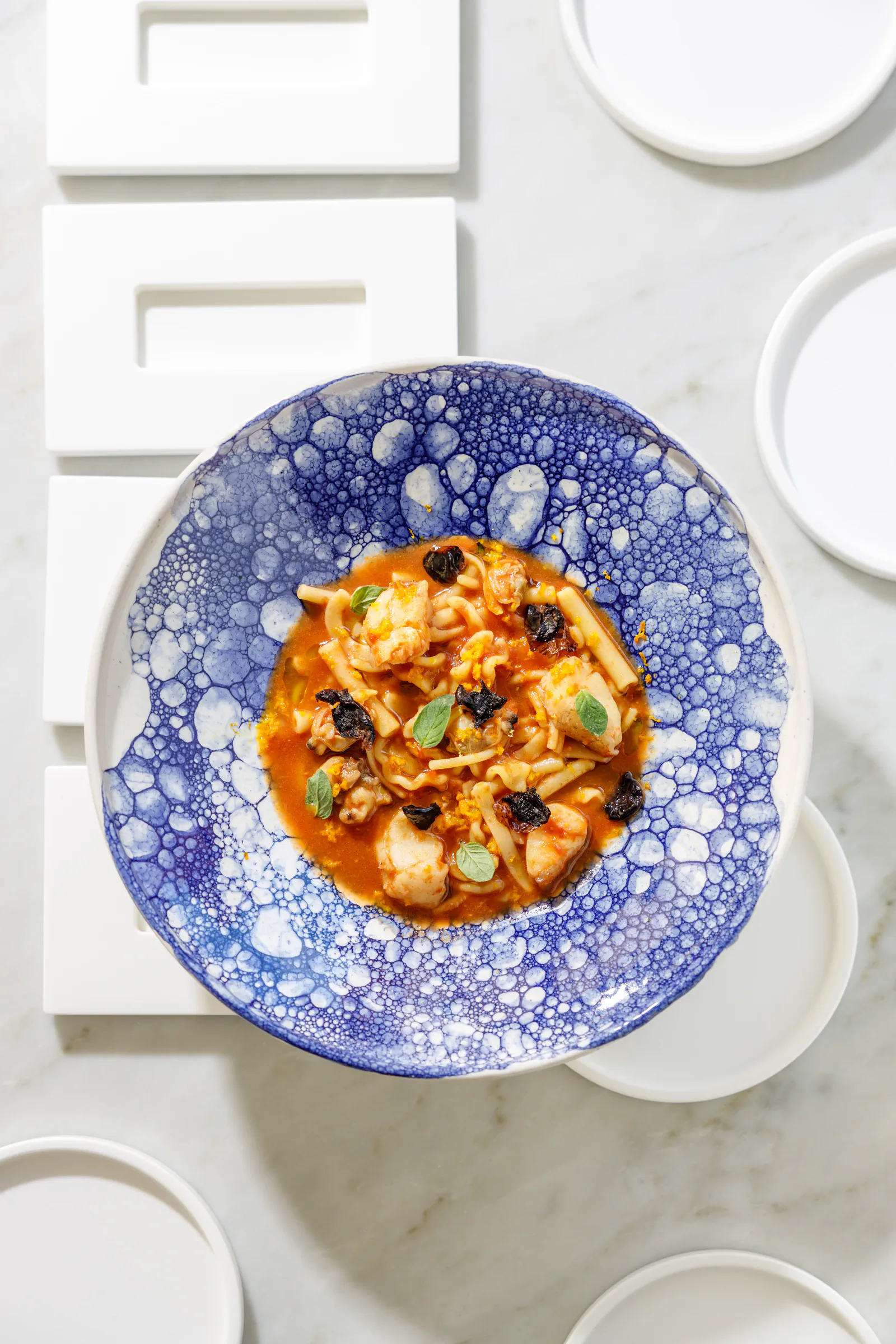 Seafood dish in a blue speckled bowl, seen from above - Taverna di Bacco, Nettuno, Italy