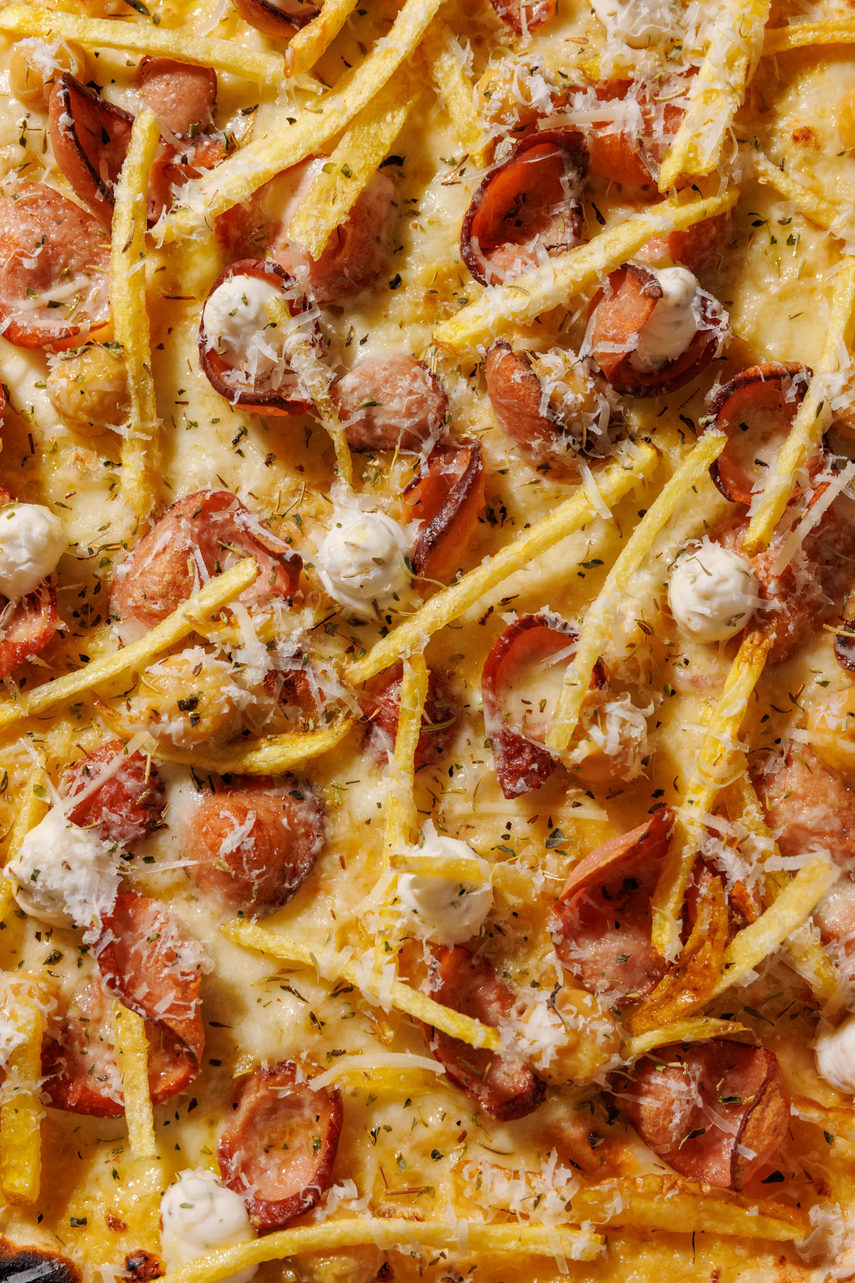 Pizza topped with french fries, wurstel and mozzarella - SEU Pizza, Rome, Italy