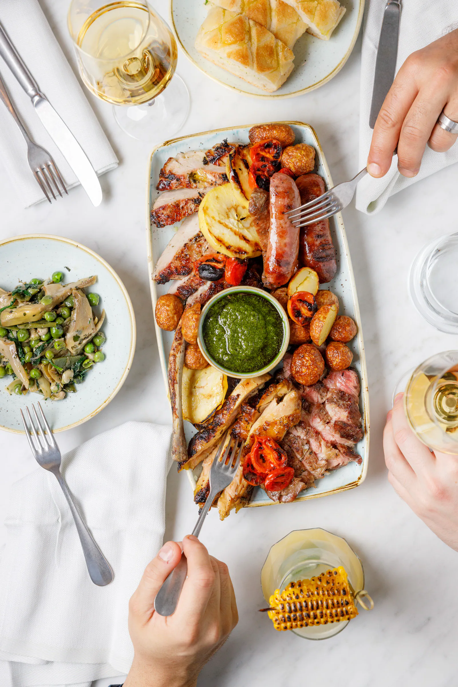 Shared mixed-grill platter with salsa verde, seen from above - The Hoxton, Rome, Italy