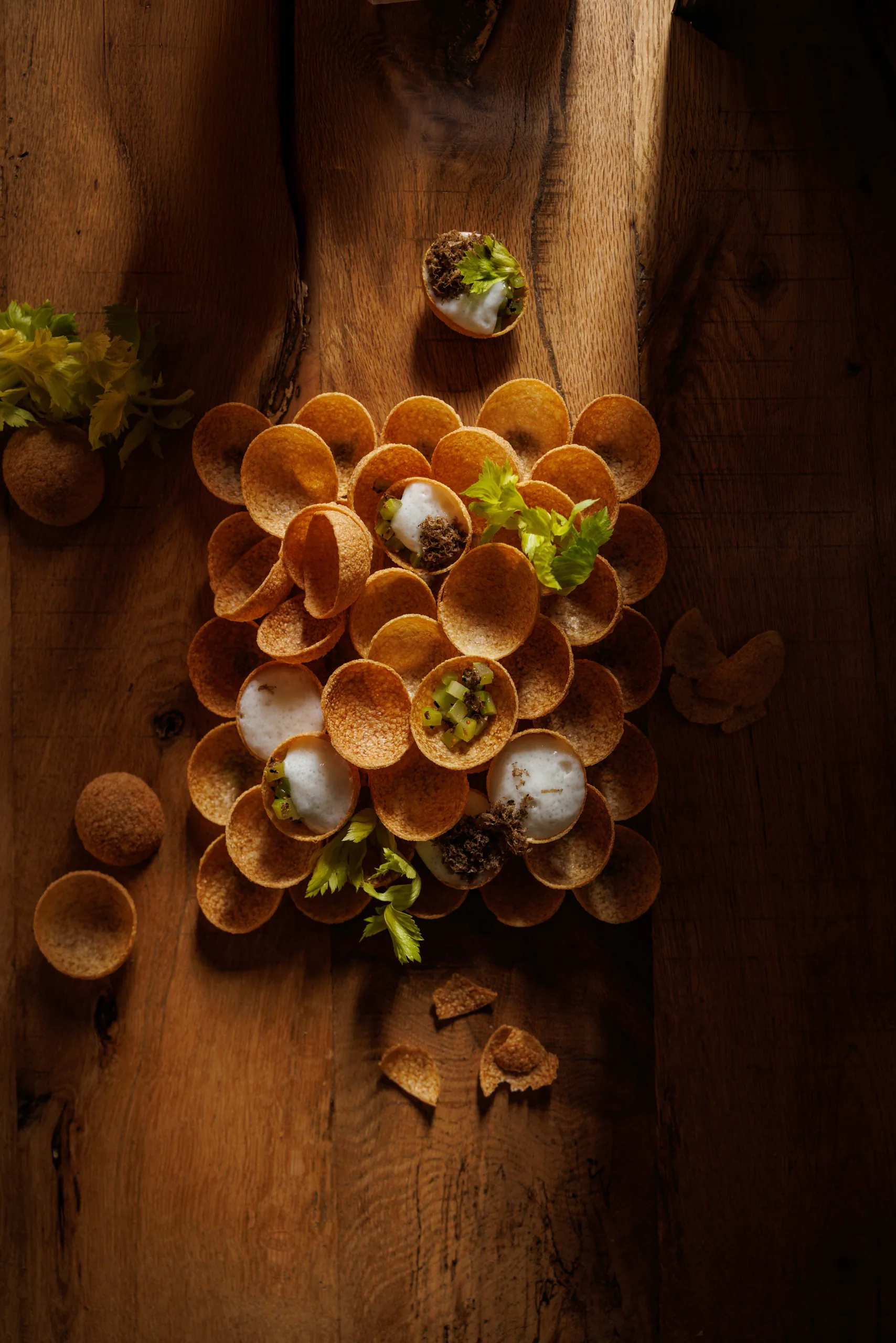 Cluster of small filled tartlets on rustic wood - UNE, Capodacqua, Italy