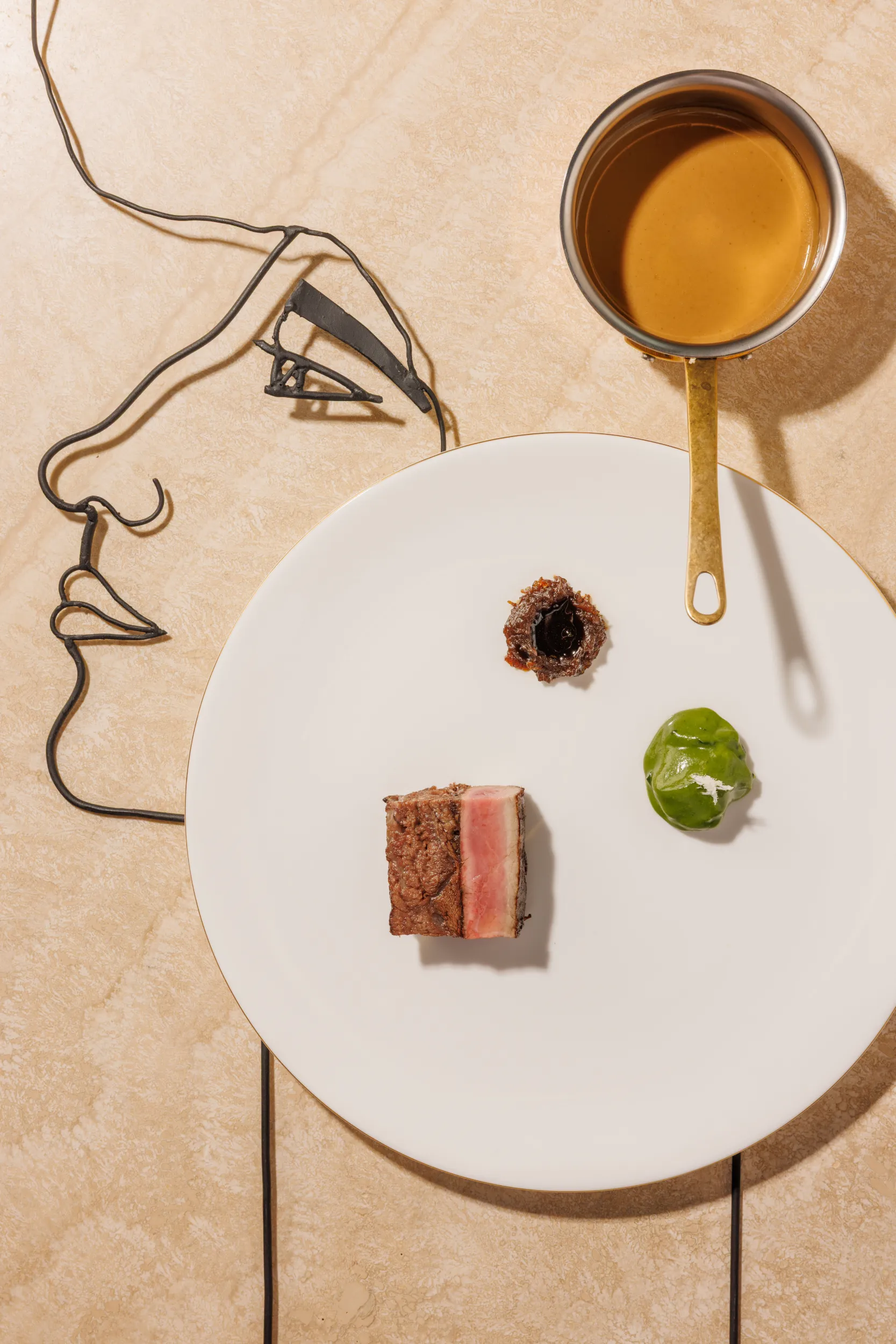 Minimalist plated bite with sauce dots and a copper pan - QUID, Rome, Italy