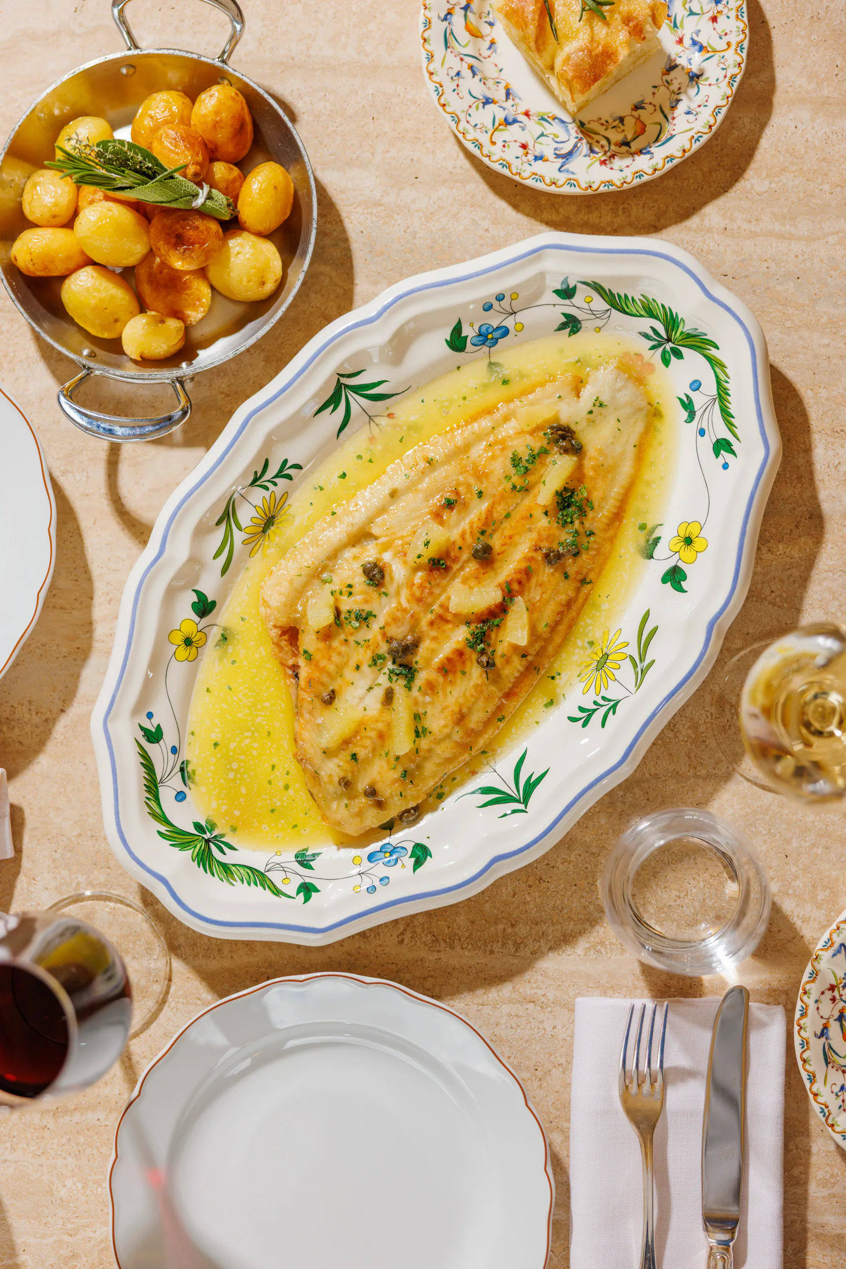 Sole fillet in butter sauce with roast potatoes, seen from above - Gigi Rigolatto, Orient Express Rome, Italy