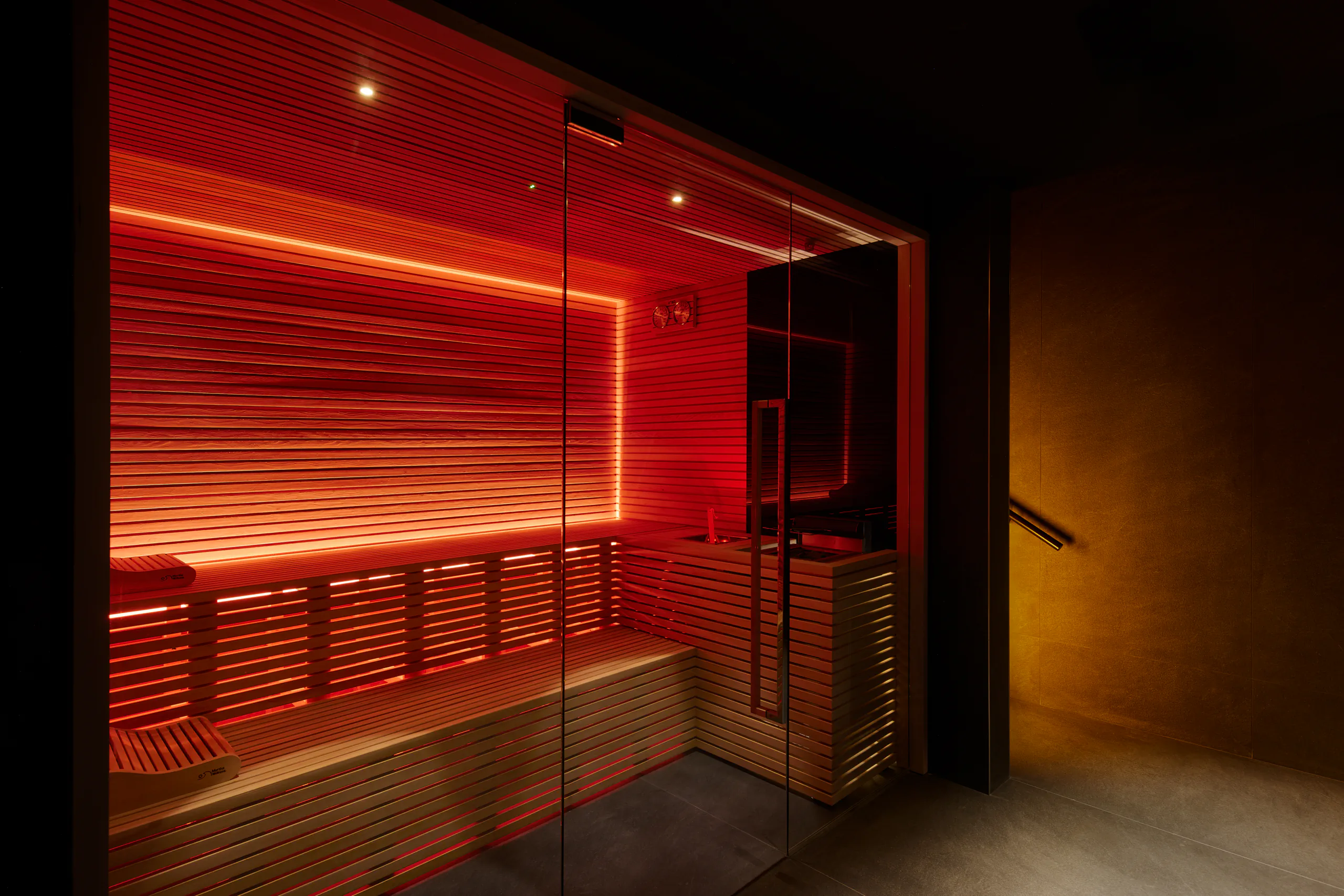 Red-lit sauna with wooden slatted benches — art'otel, Rome