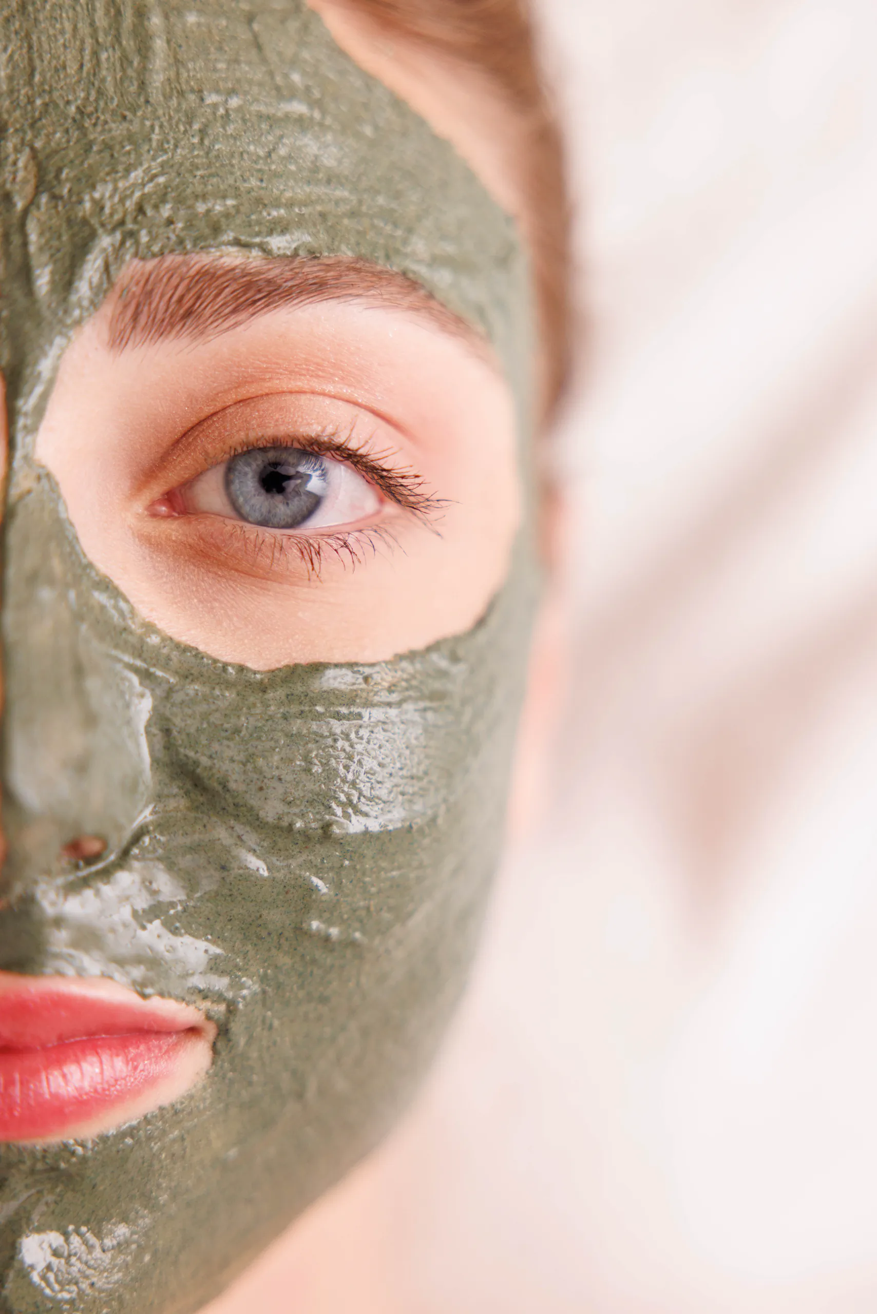 Close-up of a face with a green clay mask during a spa treatment