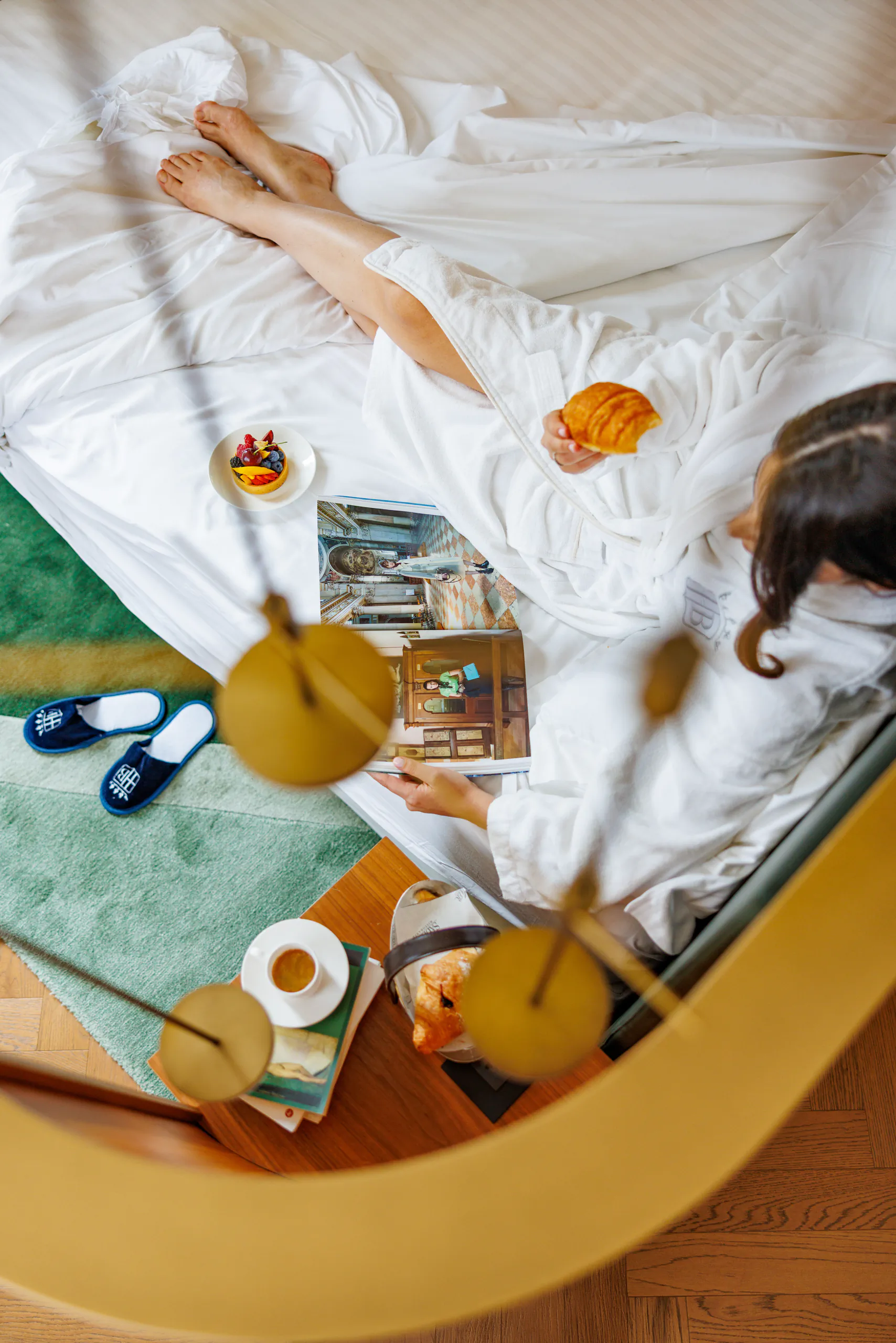 Breakfast in bed served on a tray with drinks and food, seen from above