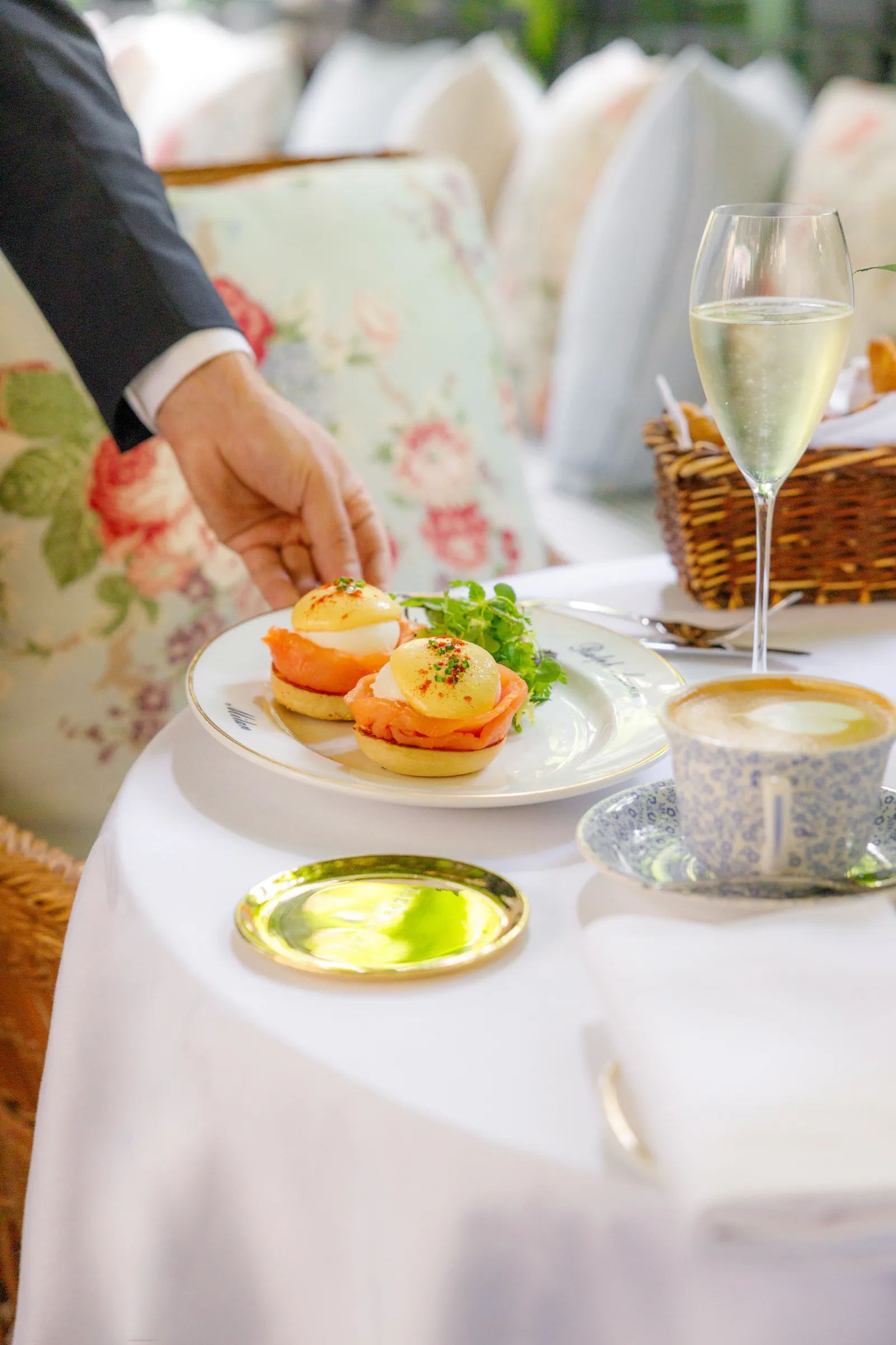 Detailed place setting with a green glass on a white tablecloth