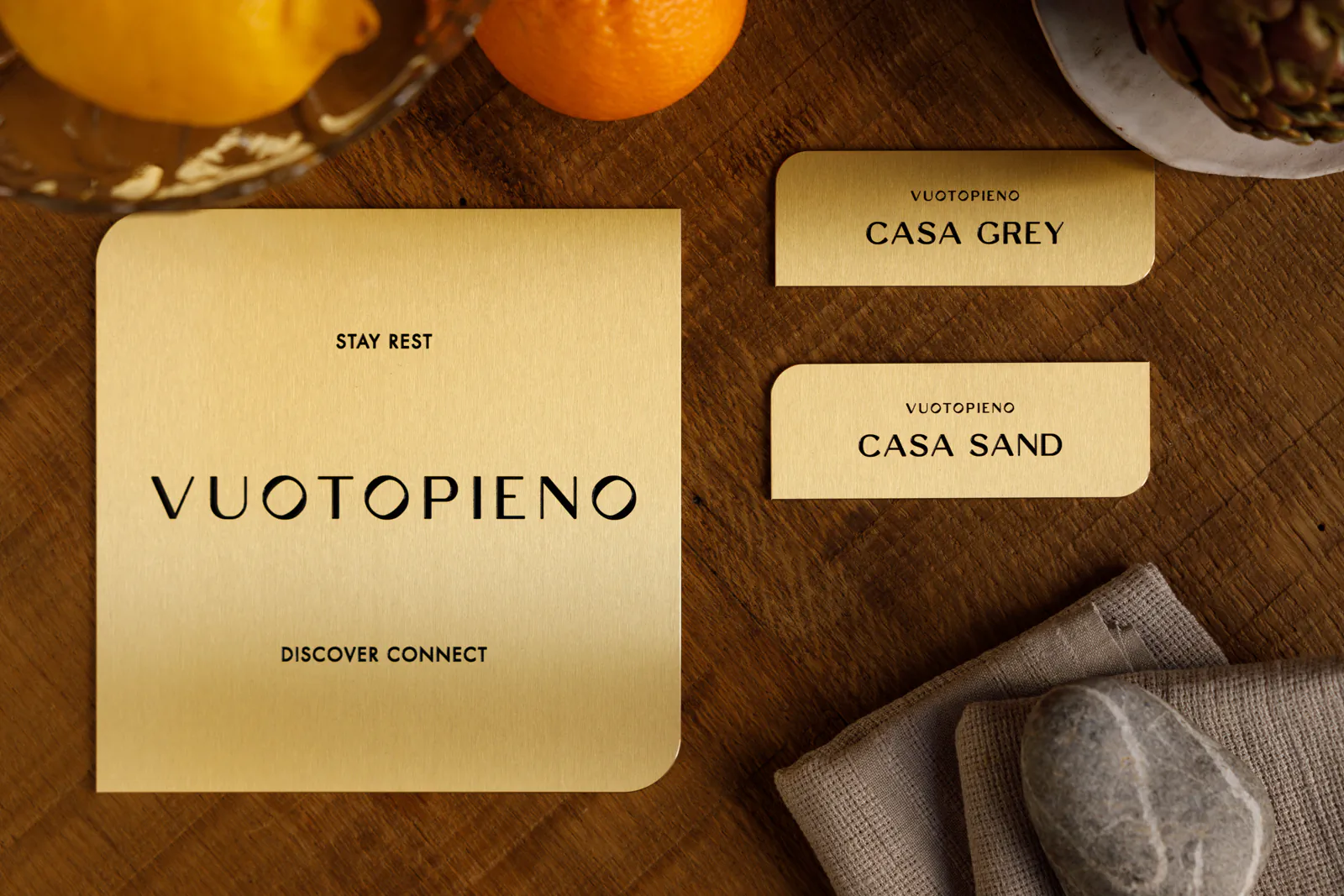 Branded stationery cards reading 'Vuotopieno' on a wooden surface