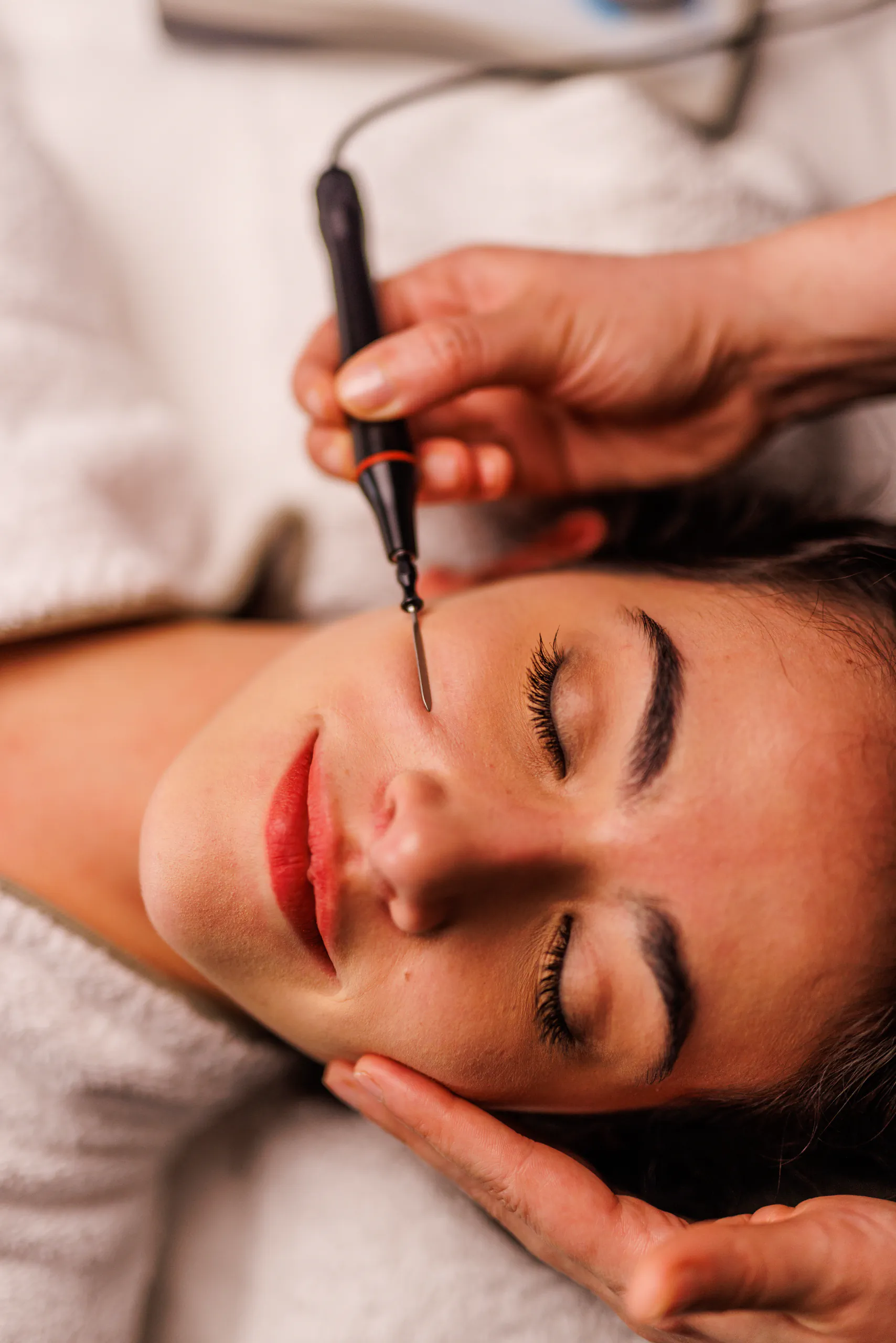 Close-up of a facial treatment with a brush at a spa
