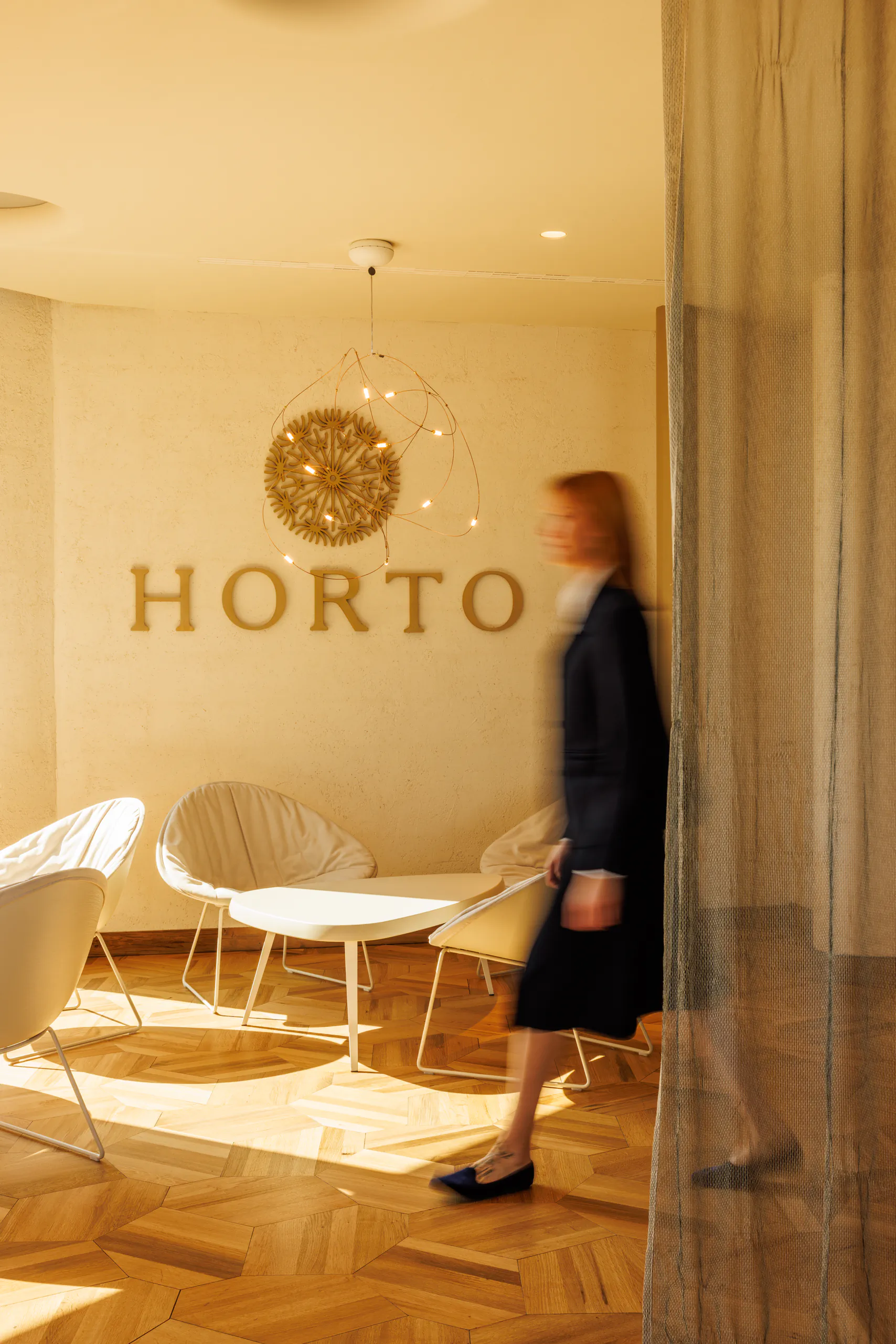 Restaurant entrance with 'Horto' signage and a person walking — Horto, Milan
