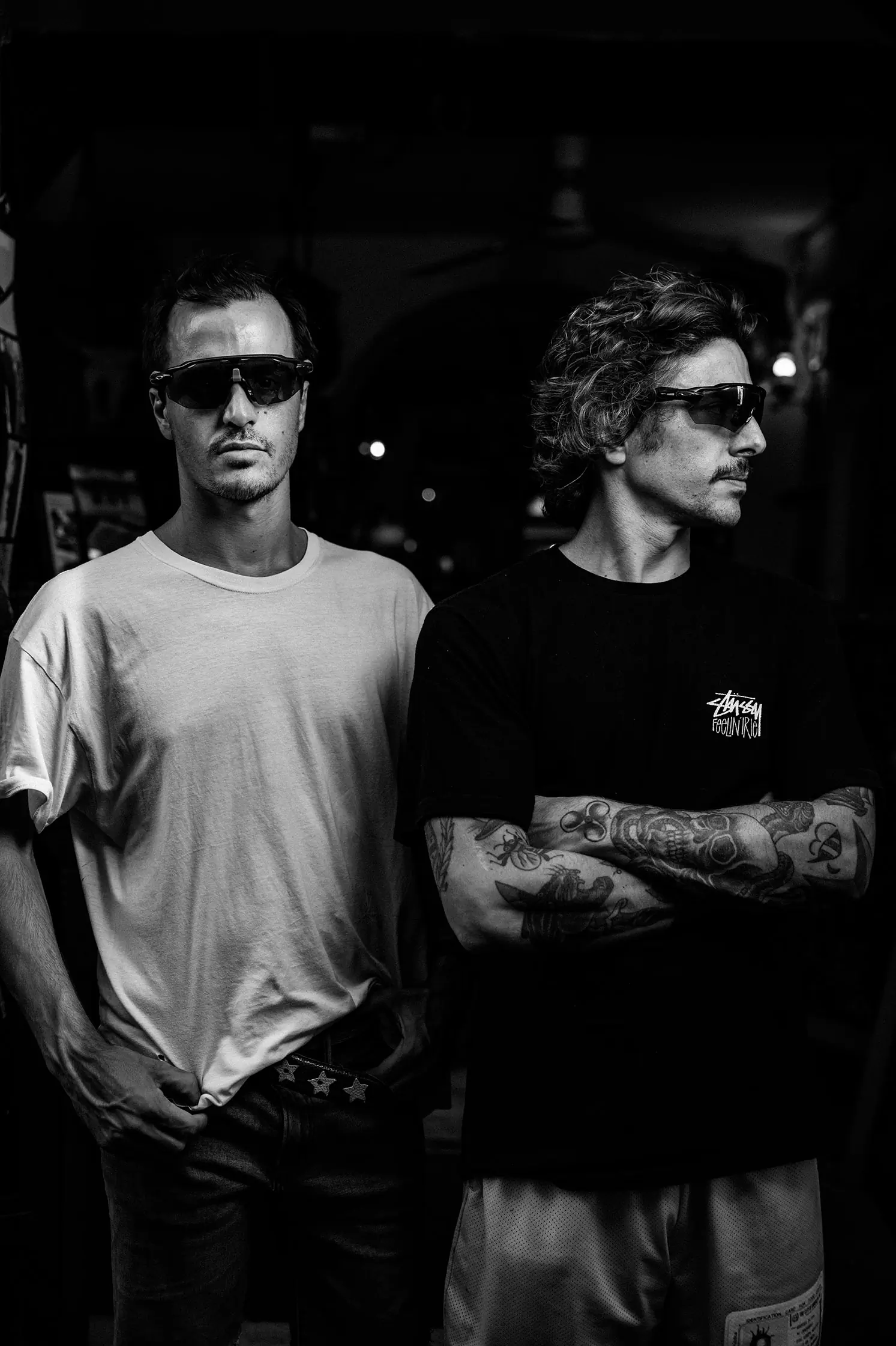 Black-and-white portrait of two young men in sunglasses