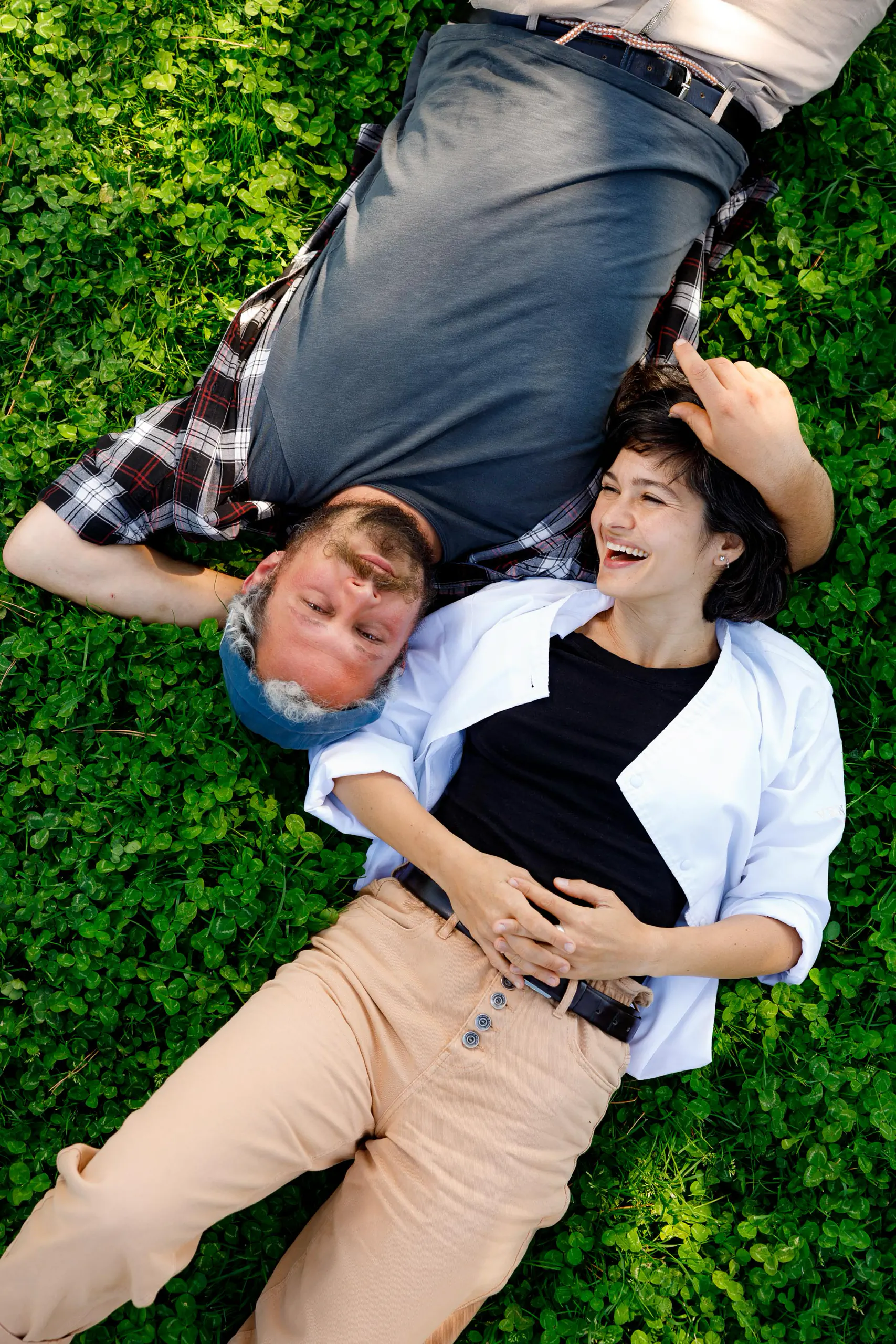 Two people lying on the grass, seen from above