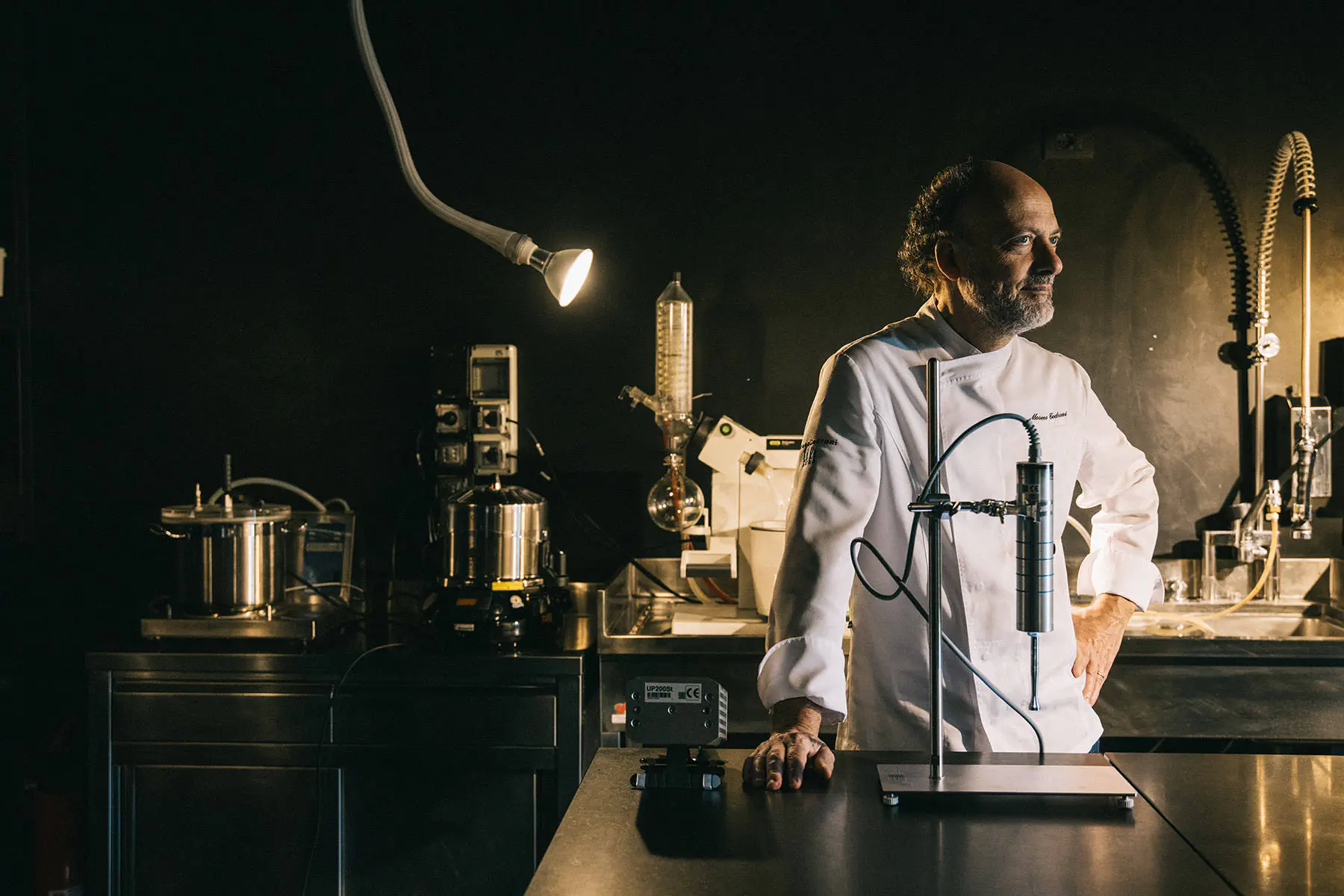 Chef in a laboratory-like kitchen with scientific equipment