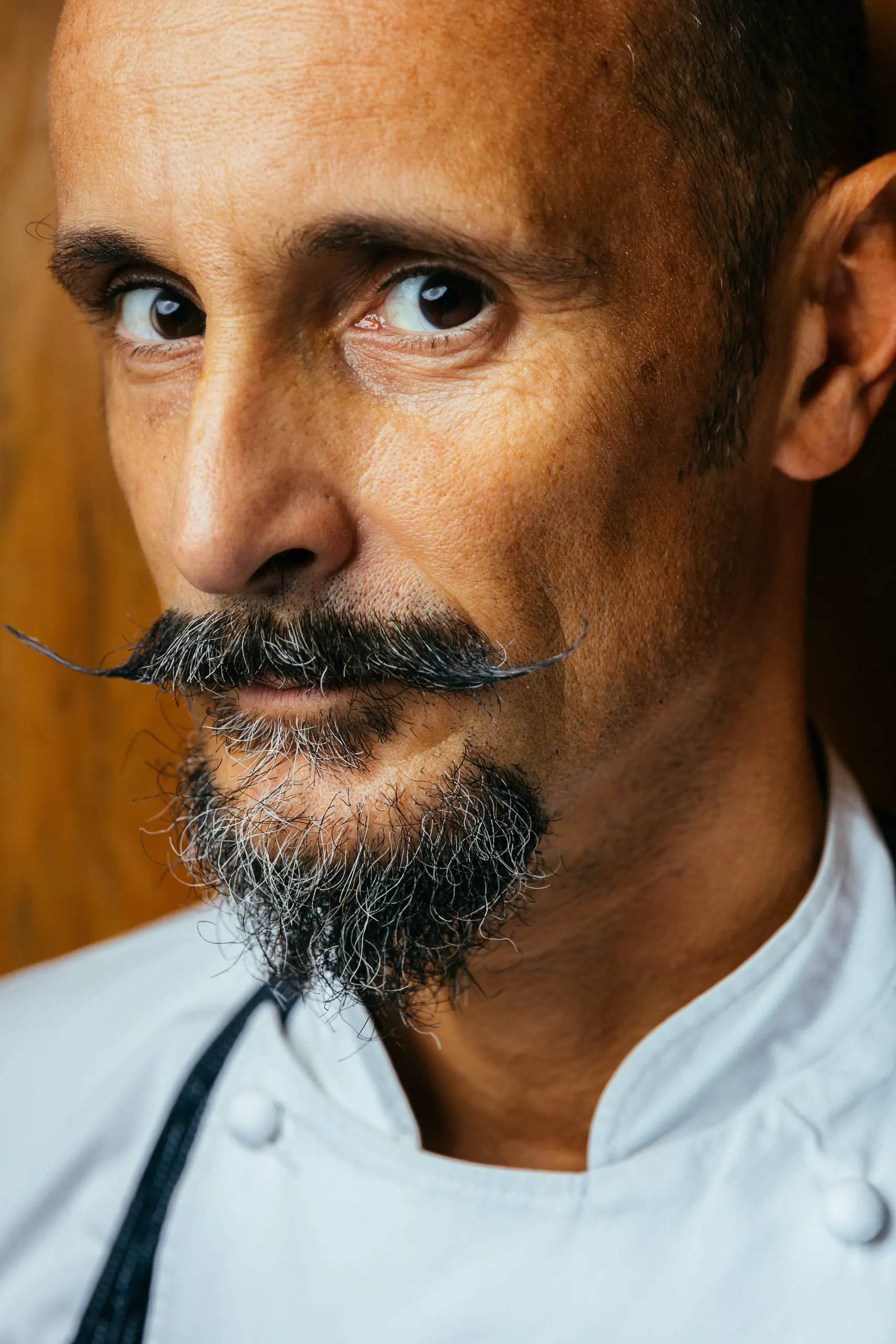 Close-up portrait of a chef with a moustache and beard