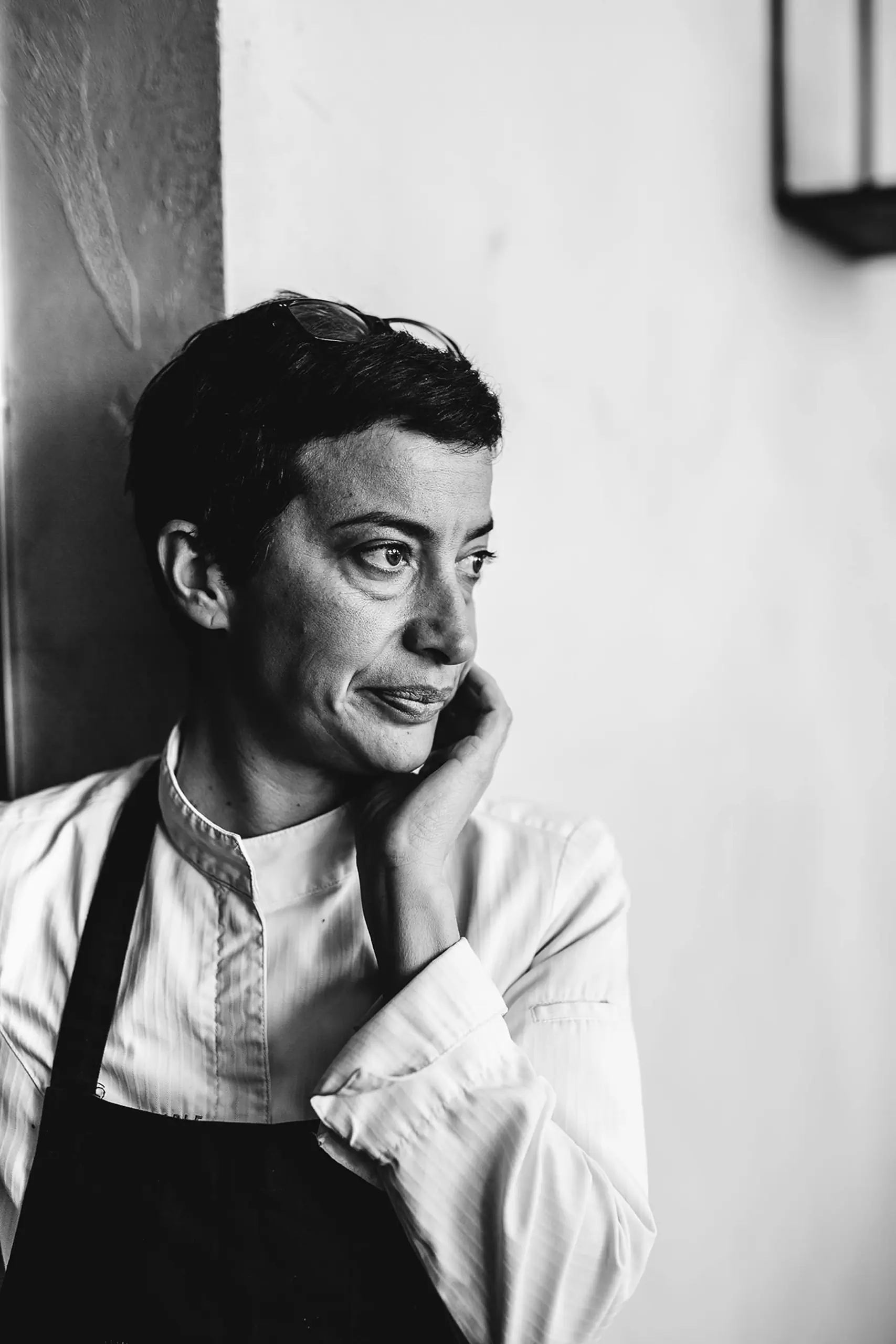 Black-and-white portrait of a person in an apron